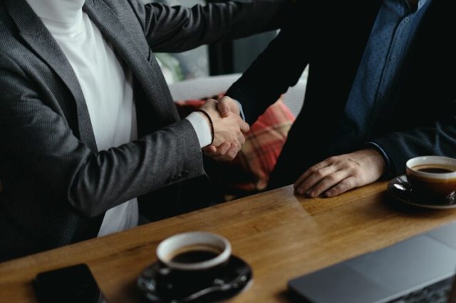 two businessmen shaking hands as sign agreement 158595 5260
